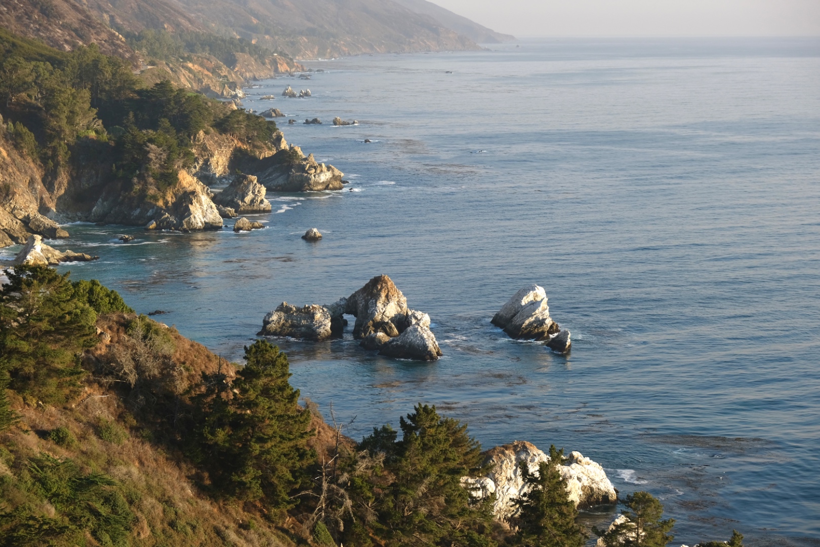 Rugged Pacific coastline with rock formations and deep blue water