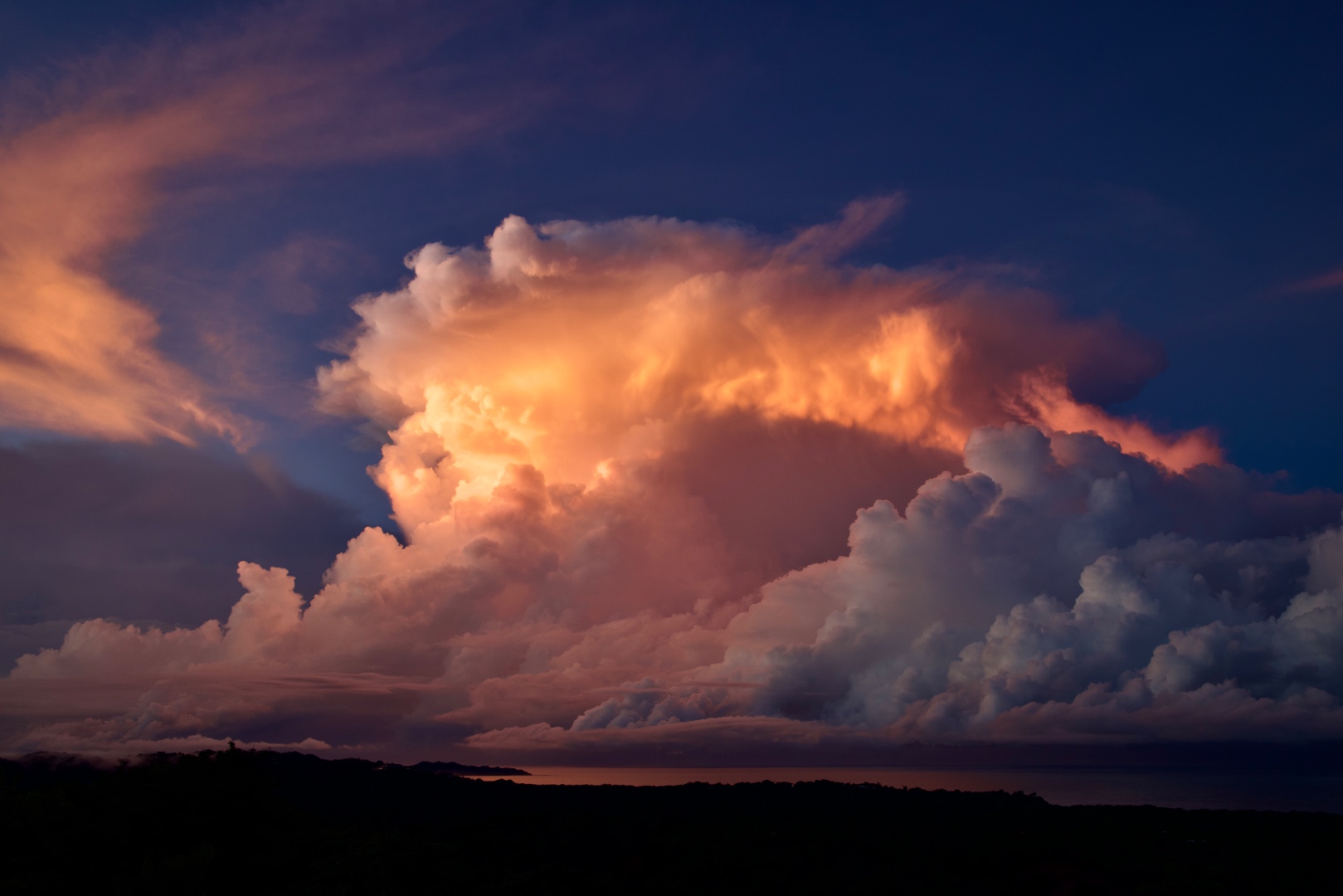 Dramatic sunset cloudscape with golden and coral light